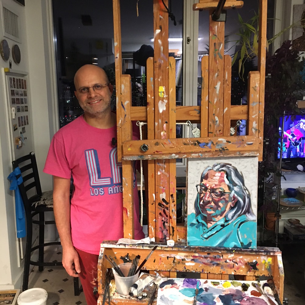 Dana Nehaaran in his studio with a portrait of Robert Curcio